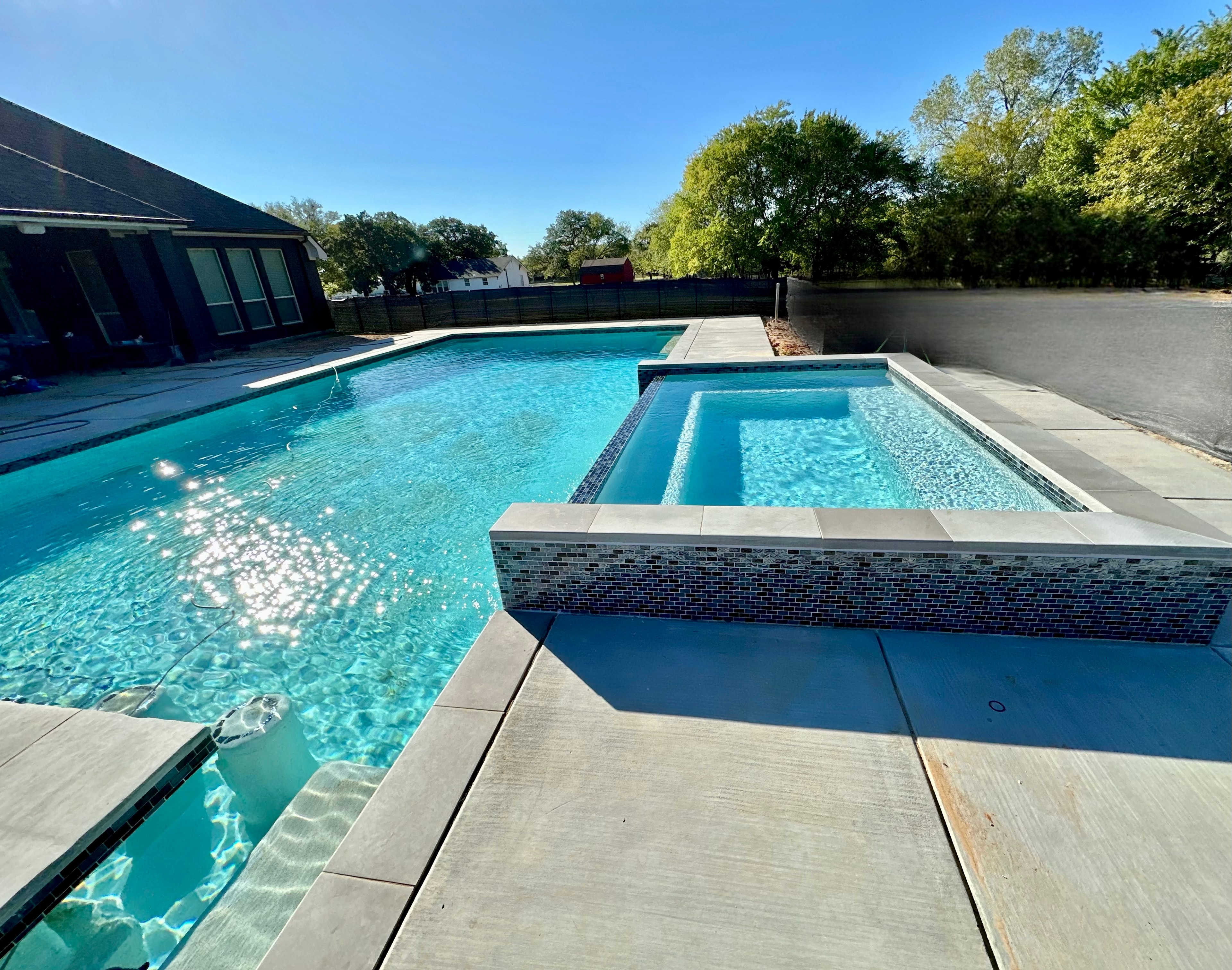 Custom geometric pool with spa and designer tile work