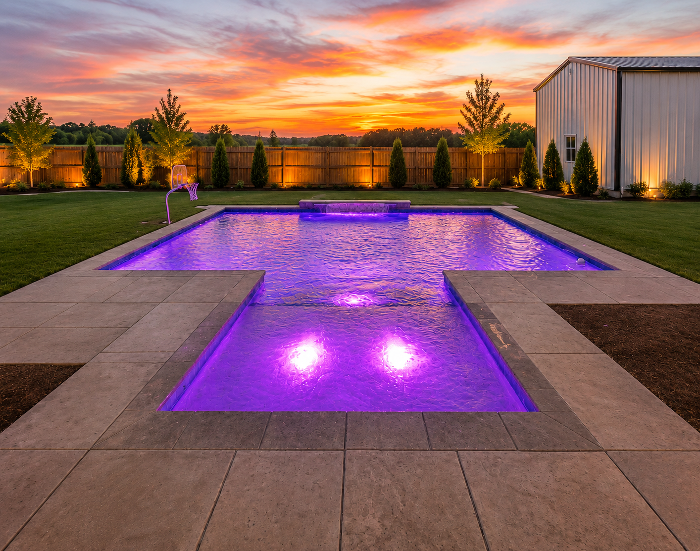 Rectangular pool with purple LED lighting at sunset