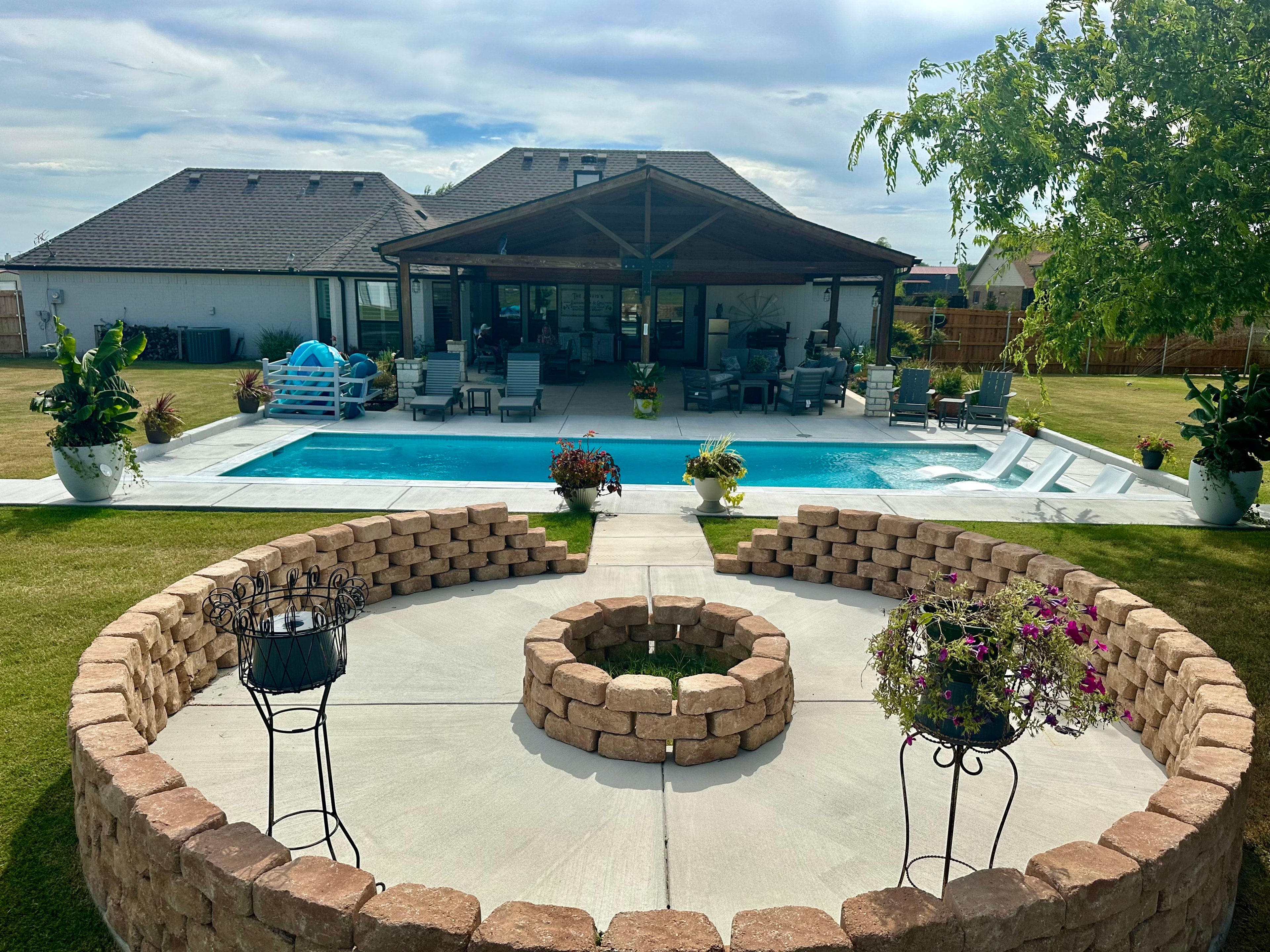 Rectangular pool with fire pit and covered pavilion