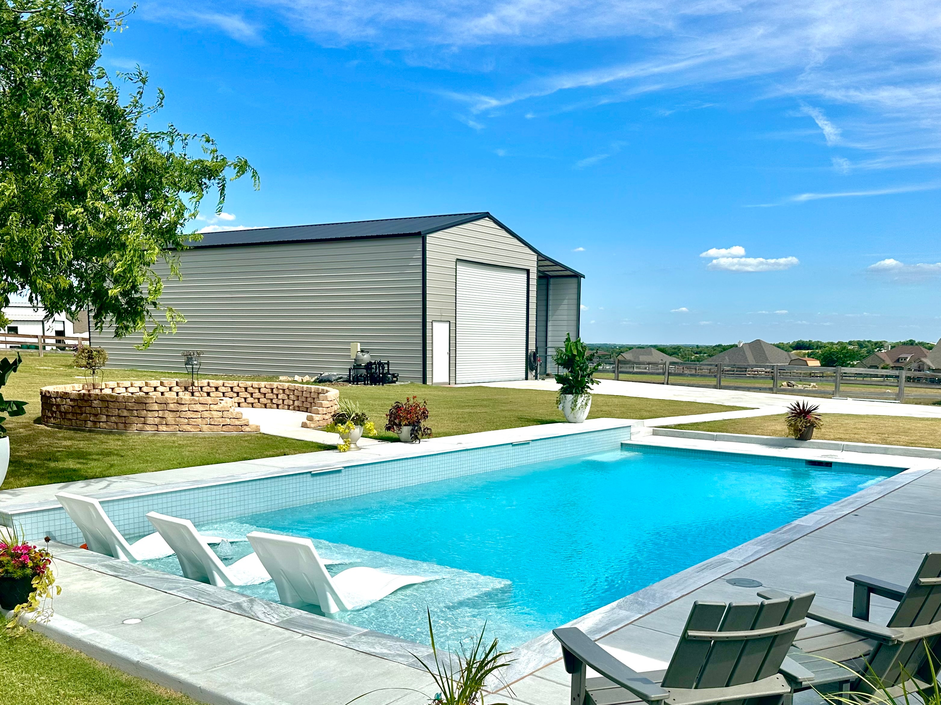 Rectangular pool with tanning ledge and barn
