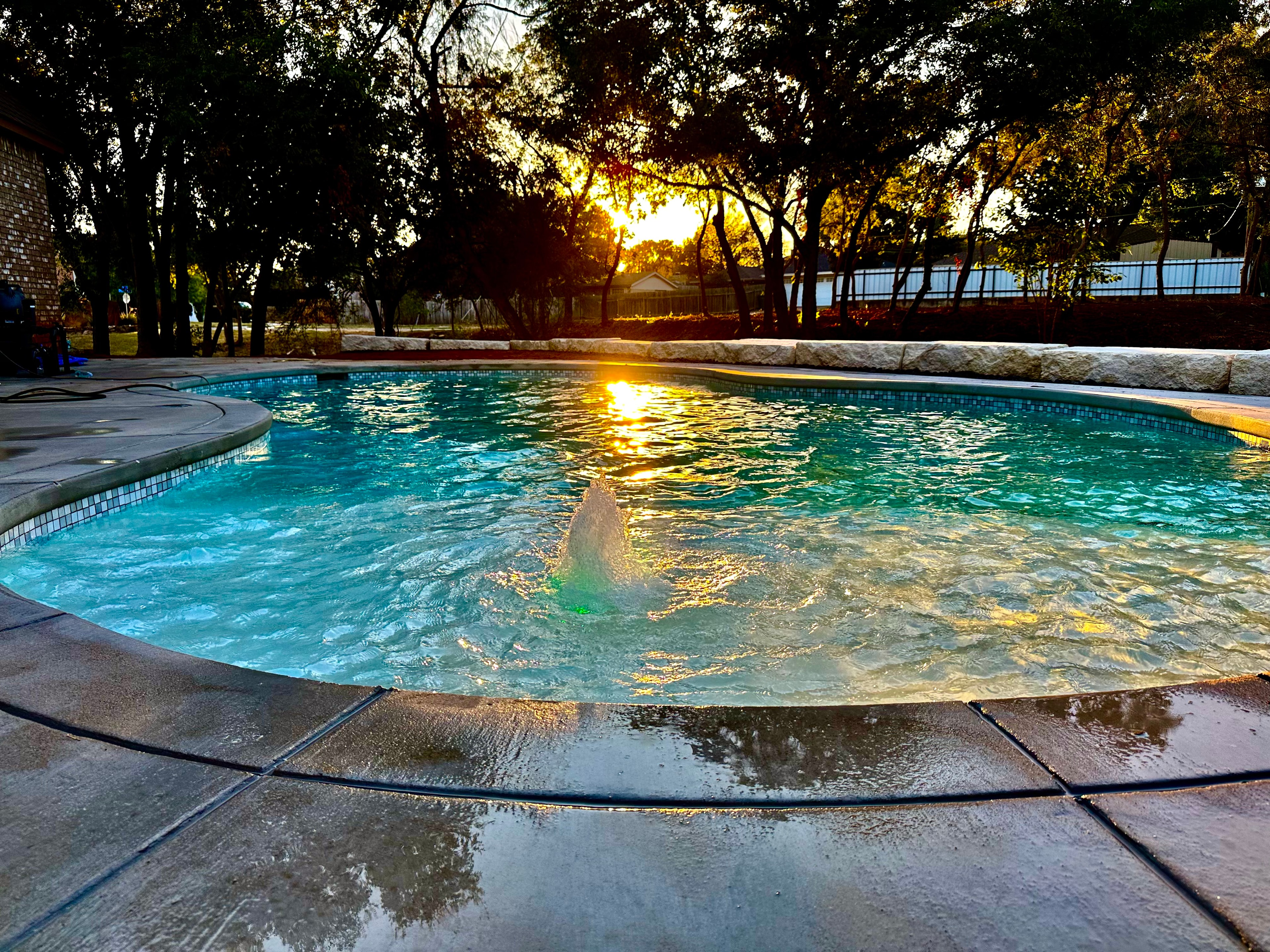 Round pool with fountain at golden hour