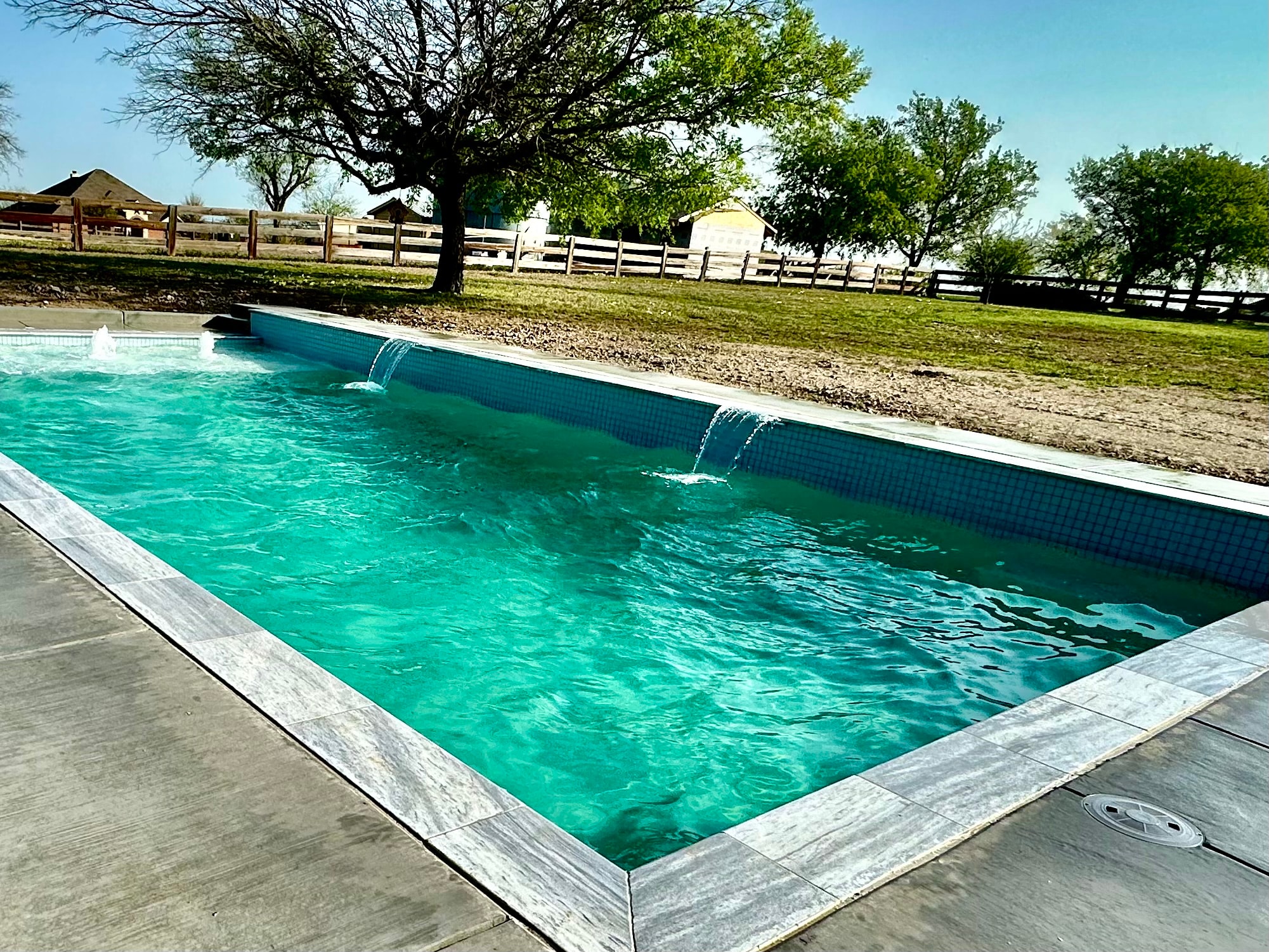 Pool with waterfall feature on a farm property